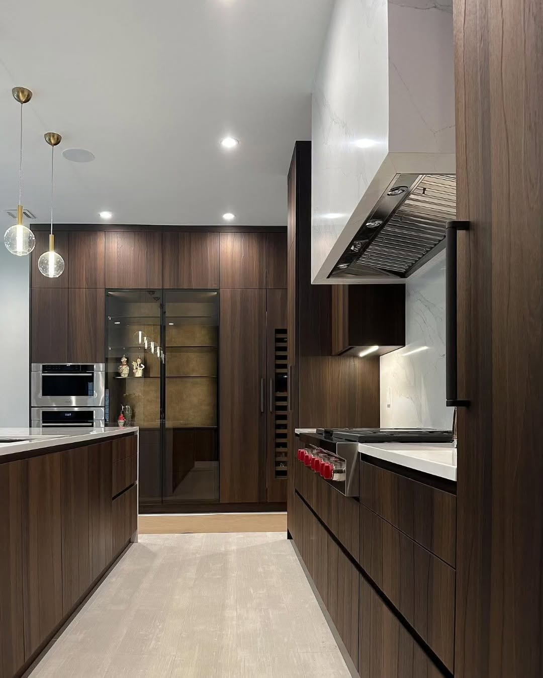Luxury walnut kitchen with marble hood and glass pantry
